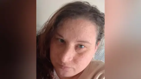 Christina Parnell A selfie-style image of Christina Parnell. She is looking directly into the camera with little emotion on her face. 