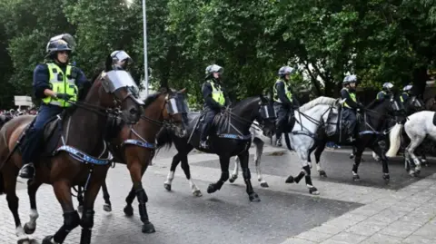 Getty Images Several police officers on horses.