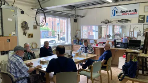 Luke Deal/BBC A group of men in the Halesworth's Men's Shed