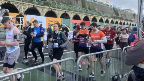 Runners pass Madeira Terrace during the 34th Brighton Half Marathon