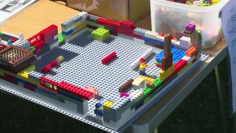 A small Lego structure depicting a pub. Multi-coloured Lego bricks have been used to create a square structure. 