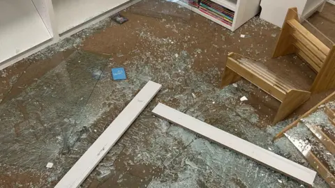 Trove UK Smashed glass covers the floor of a shop