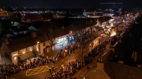 Kildare County Council/Allen Kiely A night-time aerial shot of crowds of people lining the streets of Maynooth, County Kildare, as part of the Spirit of Brigid festival