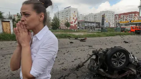 Reuters Local resident reacts at a site of a Russian air strike, amid Russia's attack on Ukraine, in Kharkiv, Ukraine May 22, 2024.