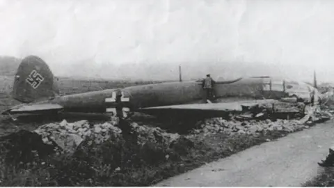 Imperial War Museum A black and white photo of a crashed German bomber plane on the Mendips. 