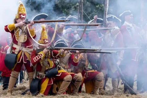 Jim Innes Re-enactment featuring people in 1745-style uniforms, amid gunsmoke