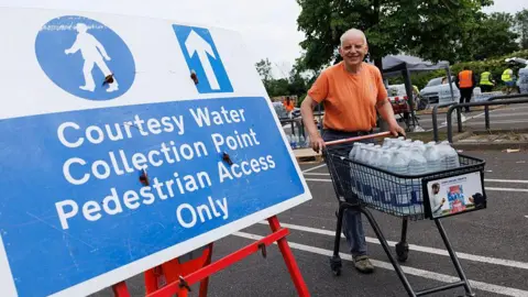Getty Images South East Water customers collect water from a collection point