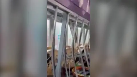 A row of metal beams bowing and twisting inside a building in New York.