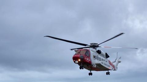 An HM Coastguard helicopter flying