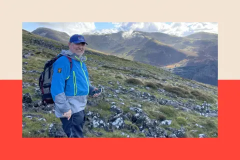 Andy Buchan in walking gear on a mountainside 