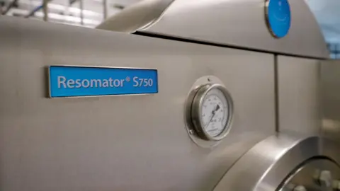 Kindly Earth A silver metal machine with a blue sign which says Resomator S750, next to a dial which measures temperature.