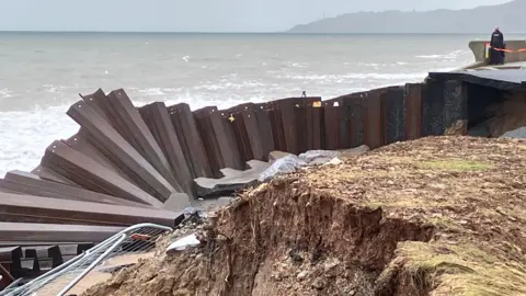 Metal sea defence panels are twisted and broken on the A379 Slapton Line between Torcross and Slapton.