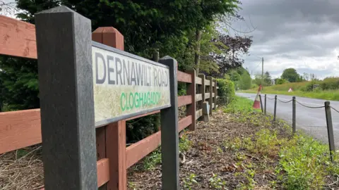 BBC Dernawilt Road sign with cone in the background