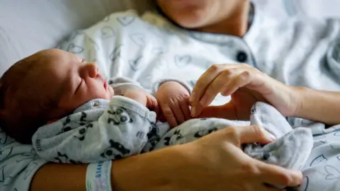 PA Media Baby and parent