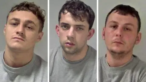 Spiers, Doran and Gill (left to right). Each of the men are wearing a grey sweatshirt. Spiers has short, brown, curly hair and is clean shaven. Doran has short, dark, curly hair and slight stubble. Gill has short, dark hair and stubble.