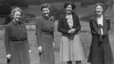 Newcastle High School for Girls Four middle aged women in a row next to the castle walls