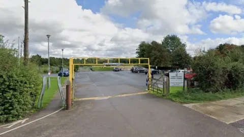 A Google Street View image shows the entrance to a council car park at the Churchdown Skatepark. 