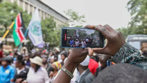 EPA A protester uses a smartphone to film the protest in Nairobi, Kenya - 18 June 2024