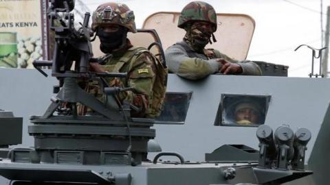 A member of the Kenya Defence Forces holds a weapon from a military vehicle as Kenya Defence Forces patrol the streets during a demonstration over police killings of people protesting against Kenya's proposed finance bill 2024/2025
