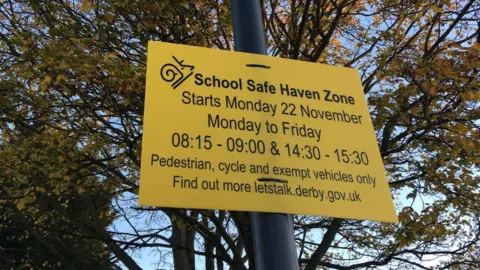 LDRS A yellow school zone sign