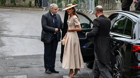 Reuters The Princess of Wales has just walked out a car, followed by the Princes of Wales.
