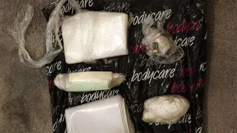 NWROCU Bags of painkillers on a black Bodycare bag and a dirty brown carpet