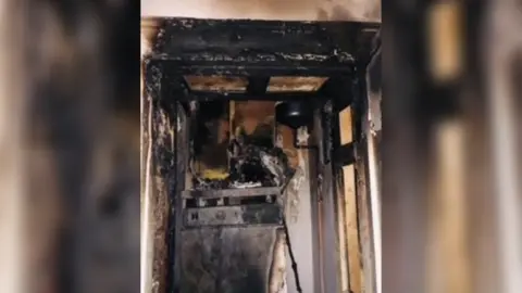 Supplied A burnt boiler cupboard which has been damaged by smoke and fire