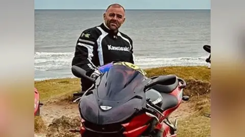 Craig "Laney" Willis with his motorbike at the beach
