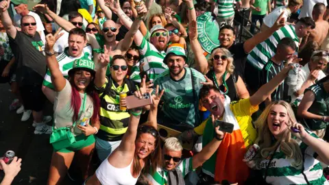 PA Media Celtic fans celebrate the title win