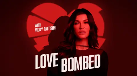 Promotional image of Vicky Pattison in which she is standing in front of a wall in shadow, leaving it a dark plum colour, with a light shining at her in the shape of a broken heart, leaving the image of the broken heart on the wall behind her. She is in her 30s and has long dark hair and has an unsmiling expression.