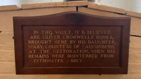 BBC/JULIA LEWIS A wooden sign explaining the contents of a vault