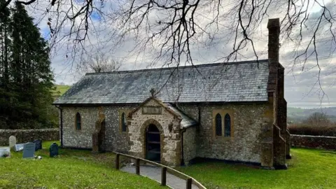 Revd Virginia Luckett St John in Fishpond church - small single storey stone church.