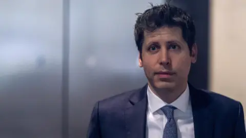 Reuters OpenAI CEO Sam Altman in the lobby of a federal courthouse in California wearing a navy suit jacket, blue necktie and white dress shirt.