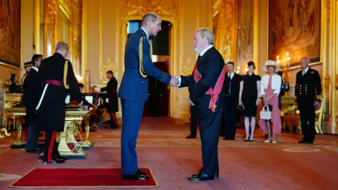 PA Sir Ridley shaking Prince William's hand