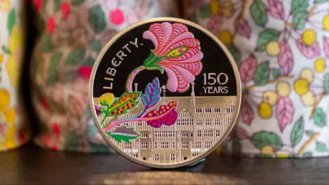  A collectable coin is unveiled at Liberty London by the Royal Mint to celebrate the department store's 150th anniversary, featuring a design created by Liberty