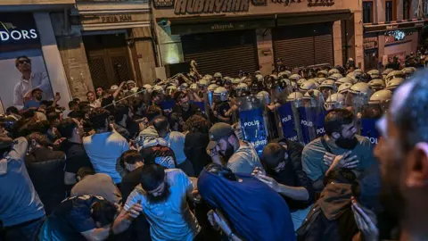 OZAN KOSE/AFP via Getty Images Protesters clash with Turkish anti riot police officers as they gather to protests Leman cartoon magazine in Istanbul