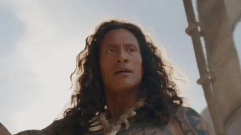 Disney Two stills from the live action Moana. On the left is a picture of Catherine Laga'aia as Moana and on the right is a still of Dwayne Johnson as Maui.