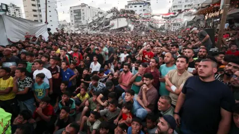 Reuters Palestinians in Gaza City watch a World Cup match between Argentina and Egypt. Photo: 7 July 2026