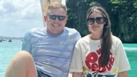 A picture of Tommy Hunter next to Chloe Mefford on a holiday next to the sea