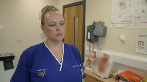 A head and shoulder shots of Ambre Au-Delves in blue medical scrubs