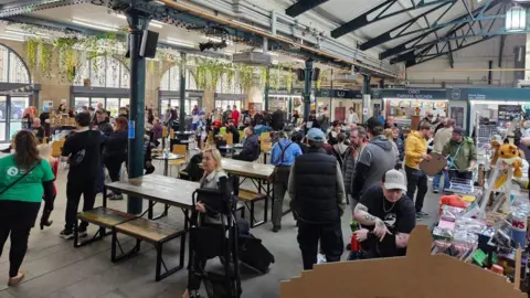 Luckbox Groups of people gathered in Trinity Market.