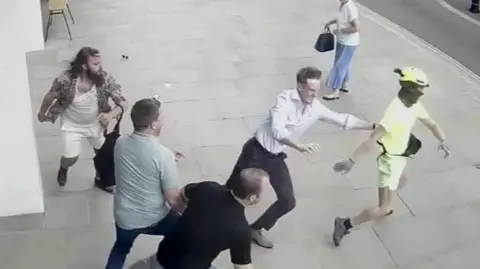 Spencer Duarte being tackled off his e-bike by members of the public after he stole a phone from a victim's hand