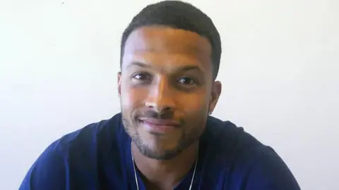 Rochdale AFC Joe Thompson. He has cropped brown hair and is wearing a dark blue t-shirt. 