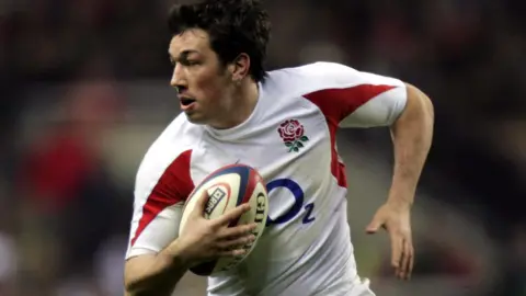 PA Media Tom Voyce playing rugby for England holding the ball.