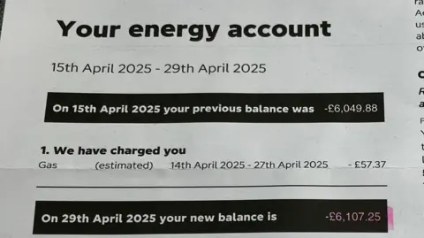 A photograph of a paper copy of the most recent energy bill shows that as of 29 April the outstanding balance of the account had risen to -£6,107.25.