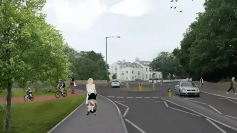 An illustration of the four-arm junction, which has a circle in the middle with yellow bollards on it. There are two cars on the road, with a woman pushing a pushchair, two cyclists and several pedestrians on the pavement.