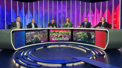Reuters A shot of the five panellists on the BBC Question Time - Greater Manchester Mayor Andy Burnham, Michael Winstanley of the Conservative Party, Liberal Democrat Jake Austin, Sarah Wakefield of the Green Party and Robert Kenyon of Reform UK