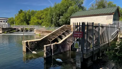 Reading Hydro Power Station that has two turbines which is not working and a gate saying Danger Keep Away