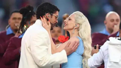 IMAGN IMAGES/Reuters Connect Bad Bunny (left) and Lady Gaga hug each other during the Super Bowl halftime at Levi's Stadium in Santa Clara, California. Photo: 8 February 2026