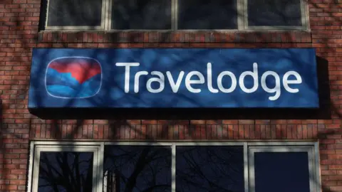 Getty Images A general view of a sign on the side of a Travelodge building of its logo. 